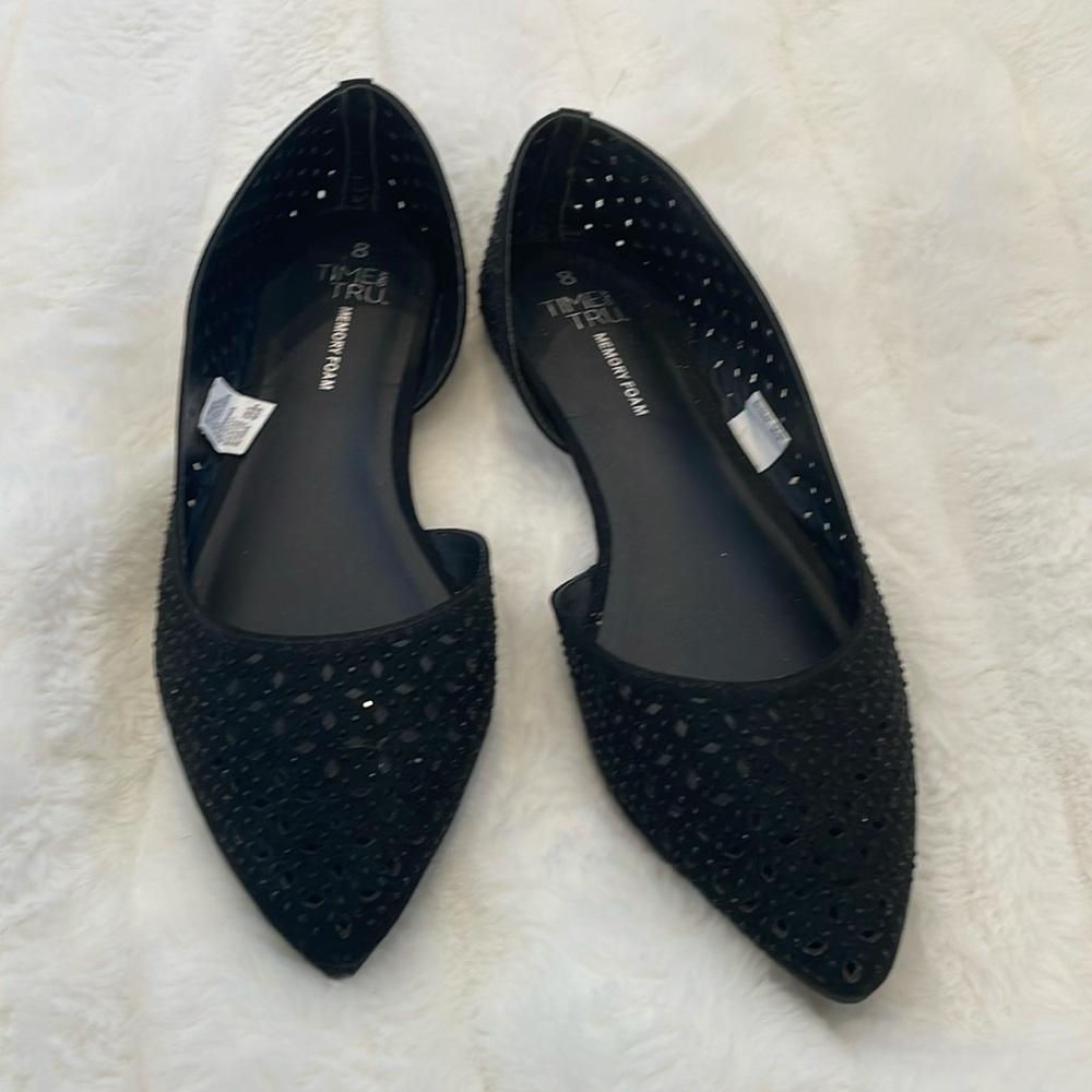 Black studded flats with pointed toes.